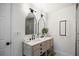 Bright bathroom featuring a double vanity, modern mirrors, and sleek black fixtures at 315 Mckees Rock Ln, Lawrenceville, GA 30044