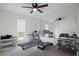 Bright bedroom featuring carpet flooring, a ceiling fan, and a large mirror wall with exercise equipment at 315 Mckees Rock Ln, Lawrenceville, GA 30044