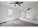 Bright bedroom featuring carpet flooring, a ceiling fan, and a large mirror wall at 315 Mckees Rock Ln, Lawrenceville, GA 30044