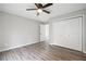 Bedroom with wood-look flooring features a closet and neutral paint, creating a bright and relaxing space at 315 Mckees Rock Ln, Lawrenceville, GA 30044