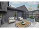 A decorated backyard deck featuring furniture, greenery, a privacy screen, and gray deck boards at 315 Mckees Rock Ln, Lawrenceville, GA 30044