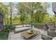 A decorated backyard deck featuring furniture, greenery, and a view of the backyard trees at 315 Mckees Rock Ln, Lawrenceville, GA 30044