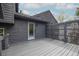 A cozy backyard deck featuring a door, a modern privacy screen, and gray deck boards at 315 Mckees Rock Ln, Lawrenceville, GA 30044