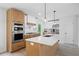 Modern kitchen boasts stainless steel appliances, a large island, and a combination of white and wood cabinets at 315 Mckees Rock Ln, Lawrenceville, GA 30044