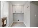 Bright laundry room featuring white cabinets and a window for natural light at 315 Mckees Rock Ln, Lawrenceville, GA 30044