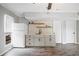 Living room features modern wet bar with grey cabinets, floating shelves, and white subway tile backsplash at 315 Mckees Rock Ln, Lawrenceville, GA 30044