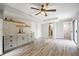 Living room with wood-look floors features stylish wet bar with white subway tile backsplash and floating shelves at 315 Mckees Rock Ln, Lawrenceville, GA 30044