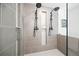 Modern bathroom shower featuring dual shower heads, gray tile, and decorative recessed niche at 315 Mckees Rock Ln, Lawrenceville, GA 30044