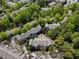 An aerial view of a well-maintained community with lush greenery and mature trees surrounding the buildings at 5523 Glenridge Ne Park, Atlanta, GA 30342