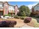 Cozy backyard with white patio furniture and landscaping outside brick townhomes at 5523 Glenridge Ne Park, Atlanta, GA 30342
