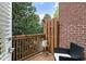 Balcony featuring chairs, potted plants, wood floors, and a brick wall at 5523 Glenridge Ne Park, Atlanta, GA 30342