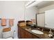 Bathroom featuring a granite vanity, a large mirror, and a toilet with pink towels hanging above at 5523 Glenridge Ne Park, Atlanta, GA 30342