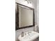 Close-up view of bathroom featuring a sink, brushed nickel fixtures, and tile mirror at 5523 Glenridge Ne Park, Atlanta, GA 30342