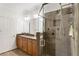 Bathroom with vanity with granite counters, wood cabinets, tile floors, and glass enclosed shower at 5523 Glenridge Ne Park, Atlanta, GA 30342