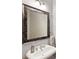 Pedestal sink bathroom with decorative mosaic framed mirror and towel bar at 5523 Glenridge Ne Park, Atlanta, GA 30342