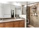 Bathroom featuring a double vanity with granite counters, wood cabinets, and a glass enclosed shower at 5523 Glenridge Ne Park, Atlanta, GA 30342