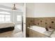 Open Primary bathroom connected to bedroom includes a jetted tub with custom tile work and natural light at 5523 Glenridge Ne Park, Atlanta, GA 30342