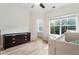 Bright room featuring wood floors, neutral walls, ceiling fan, and a large window with treetop views at 5523 Glenridge Ne Park, Atlanta, GA 30342