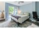 Bedroom with blue walls, wood floors, ceiling fan, and a sliding glass doors leading to a porch at 5523 Glenridge Ne Park, Atlanta, GA 30342