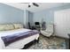 Bedroom featuring blue walls, wood floors, ceiling fan, modern chair, and work desk at 5523 Glenridge Ne Park, Atlanta, GA 30342