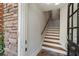 Entryway with wood stairs, stone accent wall, and an open front door at 5523 Glenridge Ne Park, Atlanta, GA 30342
