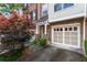 Townhome exterior with a two-car garage and a neatly kept driveway at 5523 Glenridge Ne Park, Atlanta, GA 30342
