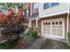 Attractive townhouse exteriors with brick and siding, well-manicured landscaping, and private garages at 5523 Glenridge Ne Park, Atlanta, GA 30342