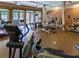 Community gym featuring modern exercise equipment and natural light from large windows and multiple ceiling fans at 5523 Glenridge Ne Park, Atlanta, GA 30342