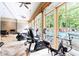 Bright gym with various machines, offering views of the outdoor pool area through expansive windows at 5523 Glenridge Ne Park, Atlanta, GA 30342