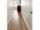 Long hallway featuring wood floors, white trim, and neutral walls at 5523 Glenridge Ne Park, Atlanta, GA 30342