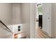 View from a hallway that shows the staircase and an open doorway to another room at 5523 Glenridge Ne Park, Atlanta, GA 30342