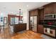 This kitchen boasts stainless steel appliances, wooden cabinets, and beautiful hardwood floors at 5523 Glenridge Ne Park, Atlanta, GA 30342