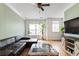 Comfortable living room with hardwood floors, a ceiling fan, and large windows at 5523 Glenridge Ne Park, Atlanta, GA 30342