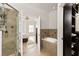 Ensuite bathroom with a soaking tub, glass shower, and open to bedroom at 5523 Glenridge Ne Park, Atlanta, GA 30342