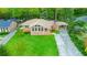 Aerial view of a brick home featuring a well-kept lawn, a carport, and a classic chimney in a tree-lined neighborhood at 698 N Superior Ave, Decatur, GA 30033