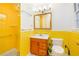 Bright bathroom with a yellow-tiled shower and vanity at 698 N Superior Ave, Decatur, GA 30033