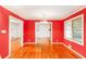 Bright dining room with hardwood floors and white trim, freshly painted in red at 698 N Superior Ave, Decatur, GA 30033