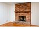 Classic brick fireplace with wood mantel and tile hearth at 698 N Superior Ave, Decatur, GA 30033