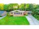 Lovely brick home featuring a spacious front yard, covered carport, and mature trees offering plenty of shade at 698 N Superior Ave, Decatur, GA 30033