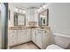 Bathroom features dual vanities with granite countertop and decorative mirrors at 751 Oneta Dr, Norcross, GA 30093