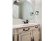 Elegant bathroom vanity with an oval sink, decorative mirror and bronze hardware accents at 751 Oneta Dr, Norcross, GA 30093