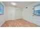 Bright bedroom with hardwood floors, closet, and white trim door to backyard at 751 Oneta Dr, Norcross, GA 30093