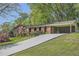 Charming brick home with a covered carport and a long driveway at 751 Oneta Dr, Norcross, GA 30093