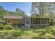 Exterior of brick home featuring a screened-in porch, a water feature and a green lawn at 751 Oneta Dr, Norcross, GA 30093