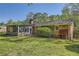 Back exterior view featuring a brick home, screened-in porch and lush green backyard at 751 Oneta Dr, Norcross, GA 30093