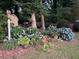 Lush garden featuring abundant blue hydrangeas, ferns, and a small decorative bird house at 751 Oneta Dr, Norcross, GA 30093