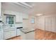 Bright kitchen featuring white cabinetry, an island, and hardwood floors at 751 Oneta Dr, Norcross, GA 30093