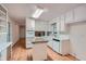 Kitchen with white cabinets, island, wood floors, and updated appliances at 751 Oneta Dr, Norcross, GA 30093