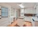 Bright kitchen featuring white cabinets, an island, hardwood floors, and lots of storage at 751 Oneta Dr, Norcross, GA 30093