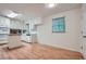 Kitchen with white cabinets, granite counters, island, window, and hardwood floors at 751 Oneta Dr, Norcross, GA 30093